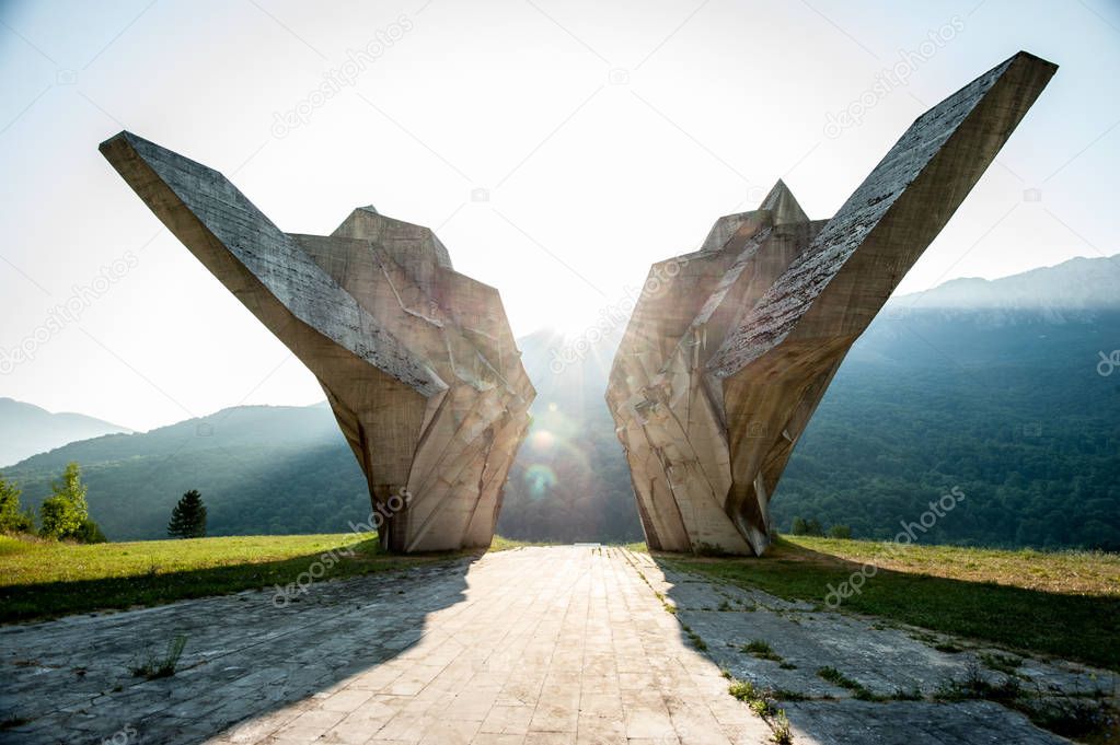 Tjentiste, Bosnia and Herzegovina - August 3 2012: Tjentiste World War II monument,Sutjeska National Park, Bosnia and Herzegovina. Monument in sunrise. Spectacular sunlight on concrete.