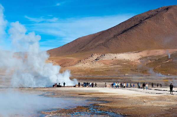 El Tatio, Atacama, Chile - January 13, 2019: Tourists watching geyser in the Los Giseres del Tatio area in the Atacama Desert, Northern Chile