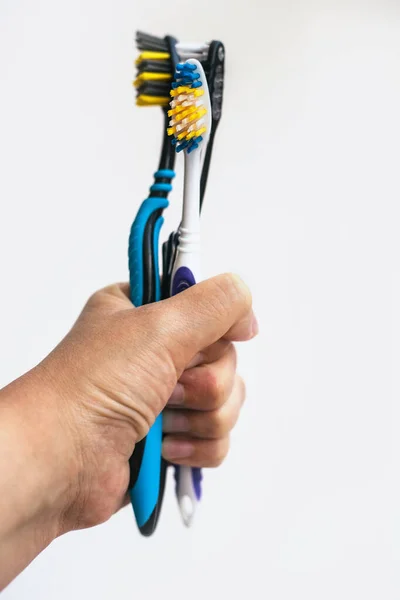 Hand holding colored toothbrushes. Oral hygiene.Soft and hard bristles.Dentistry. — Stock Photo, Image