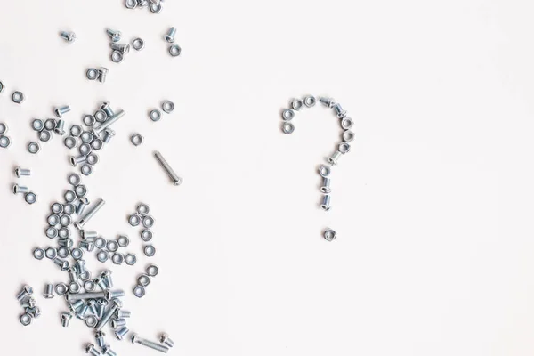Question mark lined with bolts and nuts on a white background. Question mark made of metal. — Stock Photo, Image
