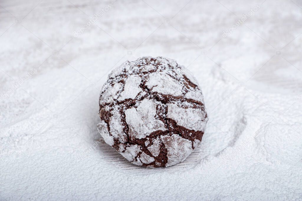 Marble chocolate cookies on a wooden stand in powder