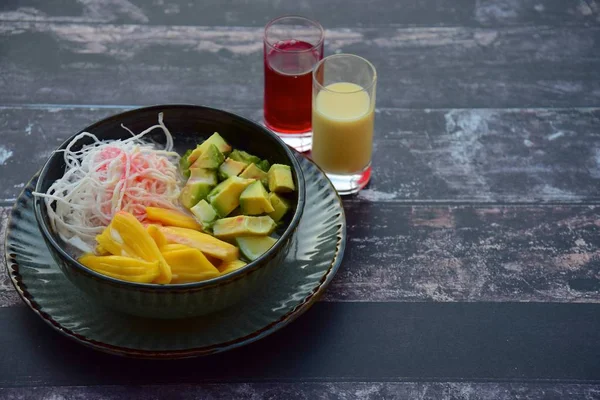 Es Teler, fruit cocktail from Indonesia. Avocado, coconut meat, jackfruit are served with coconut milk, pandan syrup and condensed milk
