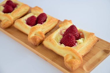 Delicious puff pastry with cream cheese and raspberries