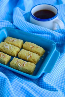 Kastengel or Kue Keju or Dutch Indonesian cheese stick cookies, served with coffee
