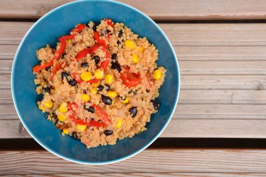 Chili quinoa bowl with black bean, corn, bell pepper, avocado and parsley