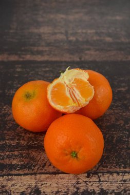 Fresh organic clementines on wooden background