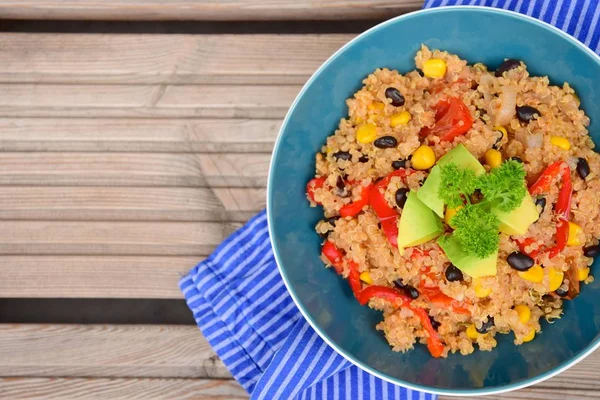 Chili quinoa bowl with black bean, corn, bell pepper, avocado and parsley