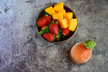 Fresh healthy vegan papaya mango strawberry smoothie