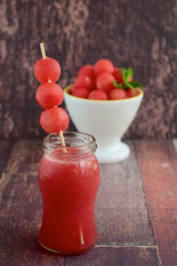 Watermelon juice and portion of watermelon balls fruit salad