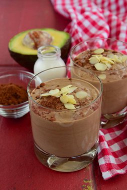 avocado chocolate smoothie on red background