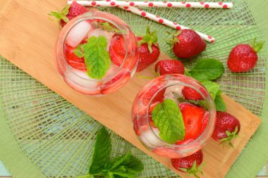 Strawberry refreshing summer drink in glasses garnish with mint leaves