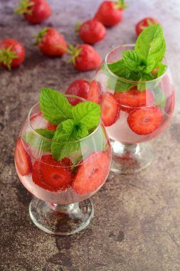 Strawberry refreshing summer drink in glasses garnish with mint leaves