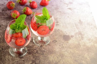 Strawberry refreshing summer drink in glasses garnish with mint leaves