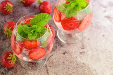 Strawberry refreshing summer drink in glasses garnish with mint leaves