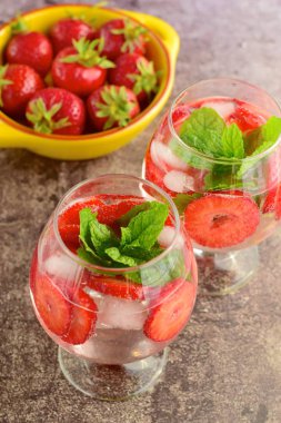 Strawberry refreshing summer drink in glasses garnish with mint leaves