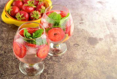 Strawberry refreshing summer drink in glasses garnish with mint leaves