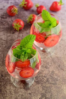 Strawberry refreshing summer drink in glasses garnish with mint leaves
