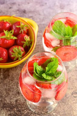 Strawberry refreshing summer drink in glasses garnish with mint leaves