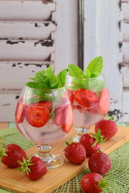 Strawberry refreshing summer drink in glasses garnish with mint leaves