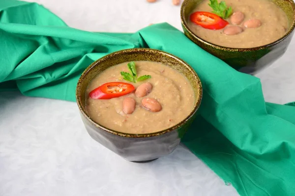 Borlotti bean or cranberry bean soup garnish with chili and parsley