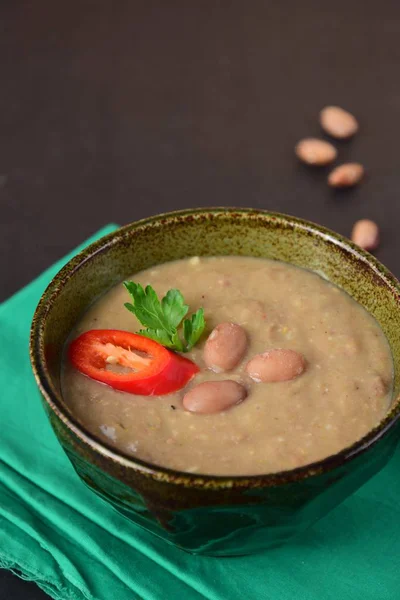 Borlotti bean or cranberry bean soup garnish with chili and parsley