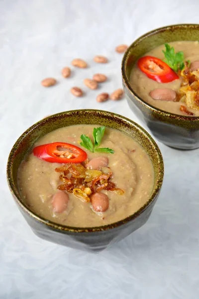 Borlotti bean or cranberry bean soup garnish with chili and parsley