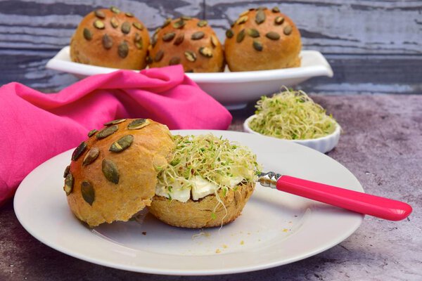 pumpkin seed bread buns with cream cheese and sprouts