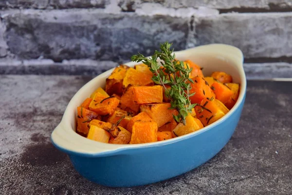 Gri arka planda kekik ile kavrulmuş tereyağlı kabak. Üst görünüm