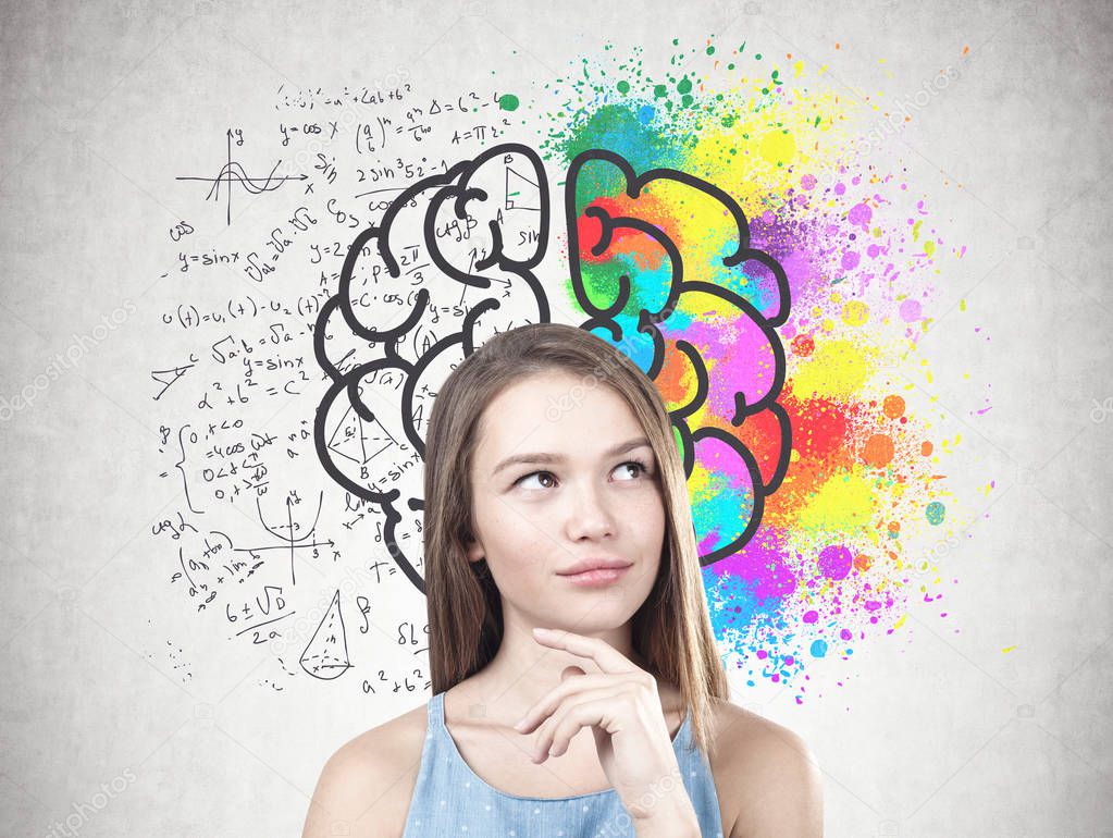 Portrait of a young woman with long fair hair wearing a blue dress and thinking. A concrete wall with a colorful brain sketch