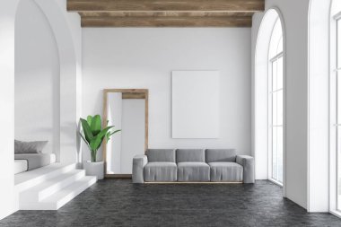 Beyaz duvarları, kemerli windows, bir beton zemin ve bir çerçeve dikey ayna ayakta bir kanepe ve poster kadar dikey sahte yanında gri kanepe oturma odası iç. 3D render