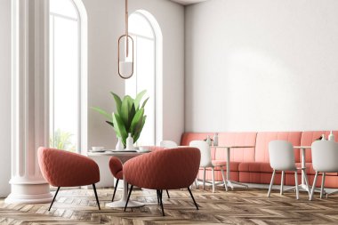 Yanında duran pembe koltuklar ile yuvarlak masa. Büyük pencereler ve sütunlar. Pembe kanepeler ile modern restoran iç. 3D render