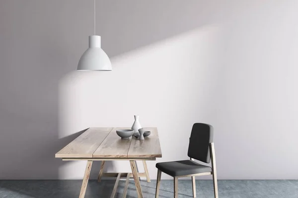White wall minimalistic Scandinavian style dining room interior with a concrete floor, a wooden table and a grey chair. A mock up wall. 3d rendering