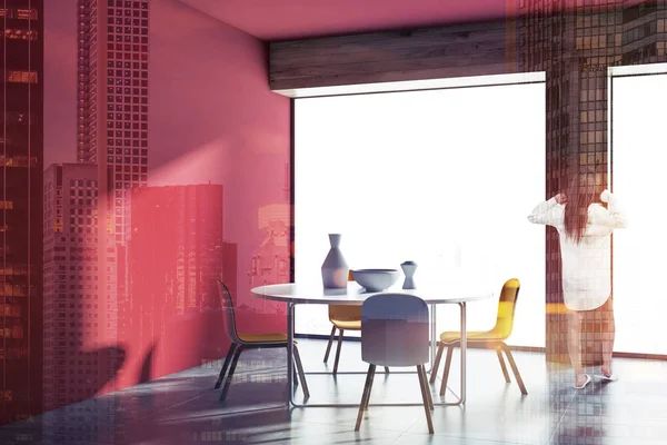 Woman in a red wall Scandinavian style dining room interior with a concrete floor, a round table and four yellow chairs. A mock up wall and a panoramic window. 3d rendering toned image double exposure