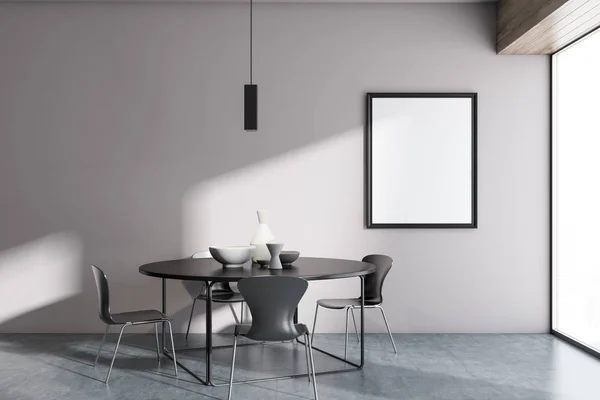 White wall minimalistic Scandinavian style dining room interior with a concrete floor, a round table and four grey chairs. A mock up vertical poster frame. 3d rendering