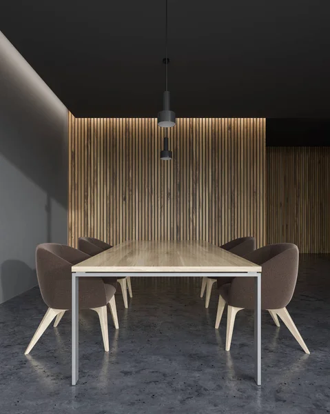 Wooden and grey wall office conference room interior with a concrete floor, a king size table and brown chairs. A mock up wall 3d rendering