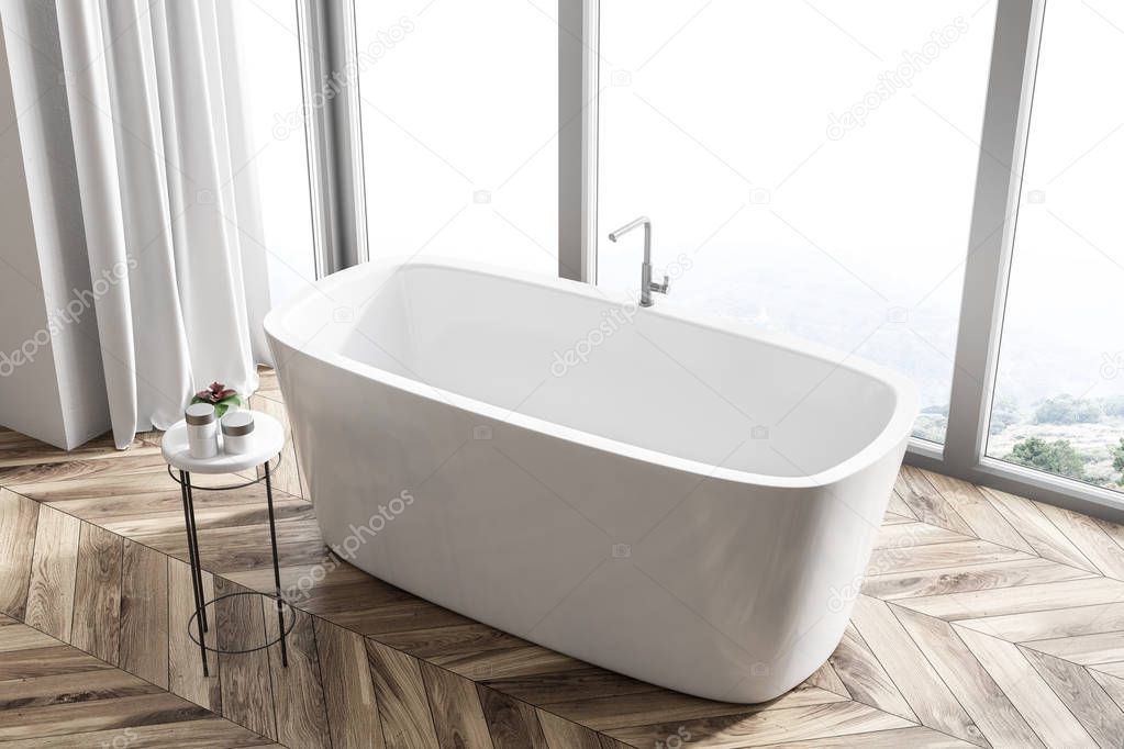 Bathroom interior with a wooden floor, a panoramic window with a mountain view and a white angular bathtub. A top view. 3d rendering