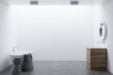Beyaz duvarlar, beton zemin, beyaz bir küvet ve ahşap lavabo ile minimalist banyo iç. Yuvarlak bir ayna. 3D render alay