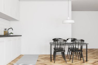 Yan görünümü bir İskandinav tarzı mutfak beyaz duvarlar, ahşap zemin, beyaz mutfak tezgahı ve dolapları ve siyah sandalye ile bir tablo. 3D render alay