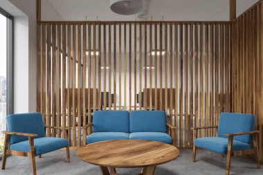 Bir yuvarlak masa, mavi koltuk ve kanepe ve ahşap duvarlar ile ofis bekleme odası iç. 3D render alay