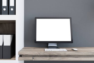 Beyaz bilgisayar ekran gri ev ofis iç ahşap bir masa üzerinde duran sahte. Bir rahat çalışma alanı ve reklam kavramı. 3D render