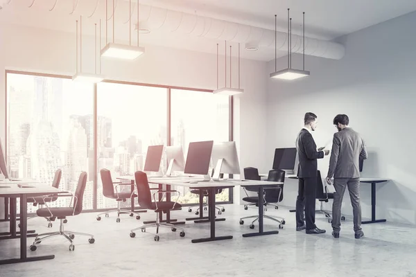 Business people talking in a modern open space office interior with white walls and floor, rows of computer tables and panoramic windows. 3d rendering mock up toned image