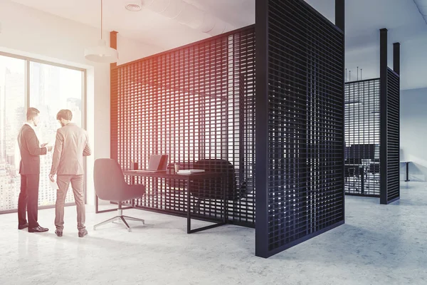 Black office cubicles with white computer tables and black office chairs. Panoramic windows. Business people talking. Side view. 3d rendering toned image