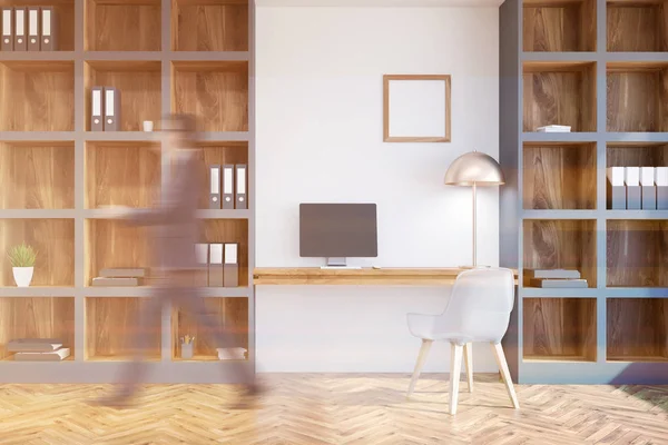 Interior of a home office interior with white walls, a computer table with a small square poster and bookcases. Businessman 3d rendering mock up toned image blurred