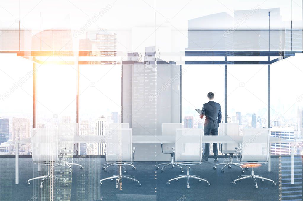 Businessman standing in an office meeting room with white chairs and table. Panoramic windows. 3d rendering mock up toned image double exposure