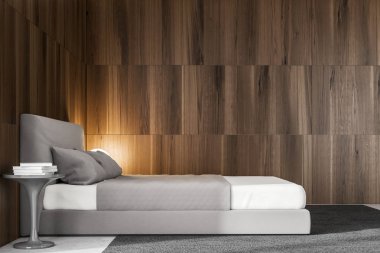 Yatak odası iç koyu ahşap duvarlar, gri bir karyola ve bir başucundaki kitap yığını. 3D render alay