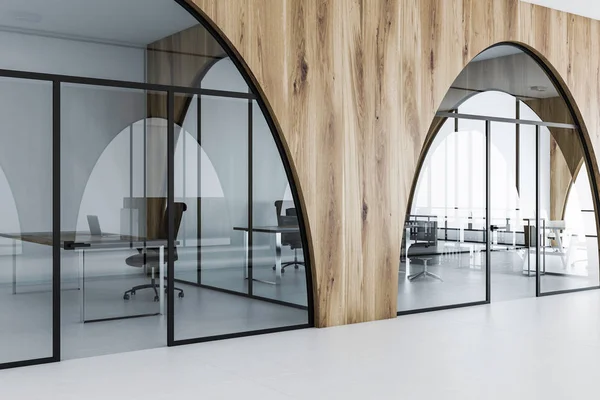 White and wooden office with a white floor, arched doorways and computer tables with black chairs standing near it. 3d rendering mock up