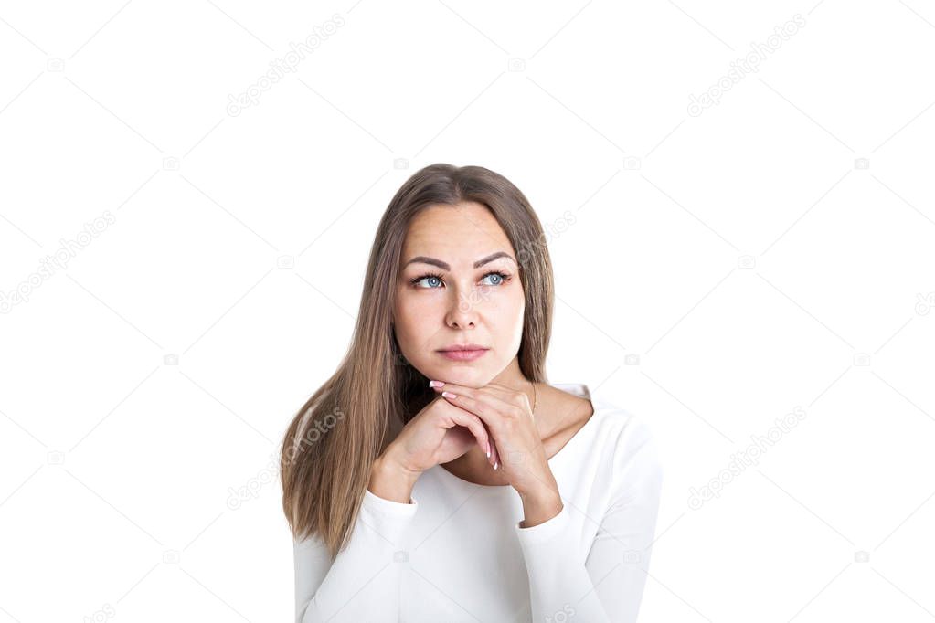 Head and shoulders portrait of a beautiful young woman with fair hair wearing white and thinking looking upwards. Concept of business creative mind. Isolated