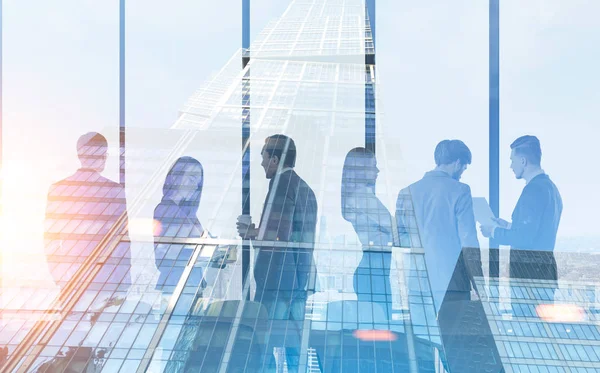 Members of a diverse business team are standing together in a panoramic office and talking. Skyscraper in the foreground. 3d rendering mock up toned image double exposure