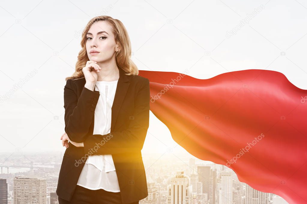 Confident and successful businesswoman wearing a suit and a red cape standing against a morning cityscape. Young, attractive and daring. 3d rendering mock up toned image