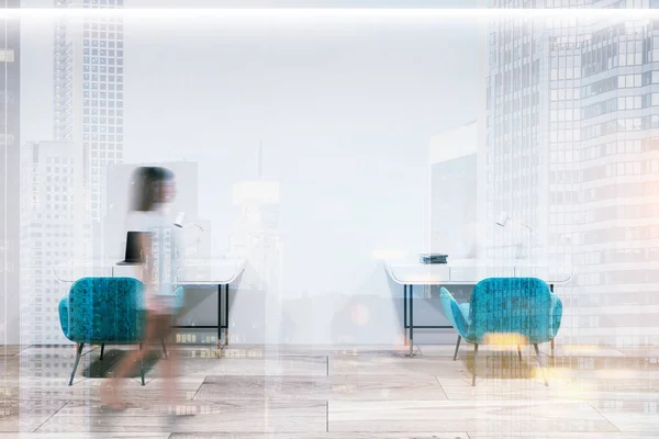 Woman near two neat small tables standing in an empty white wall room with a wooden floor. Two blue armchairs and a computer. 3d rendering mock up toned image double exposure blurred